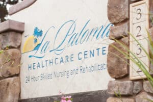 La Paloma Healthcare Center outside sign with stones around it.
