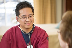 A nurser checking heart rate of a resident at La Paloma Healthcare Center